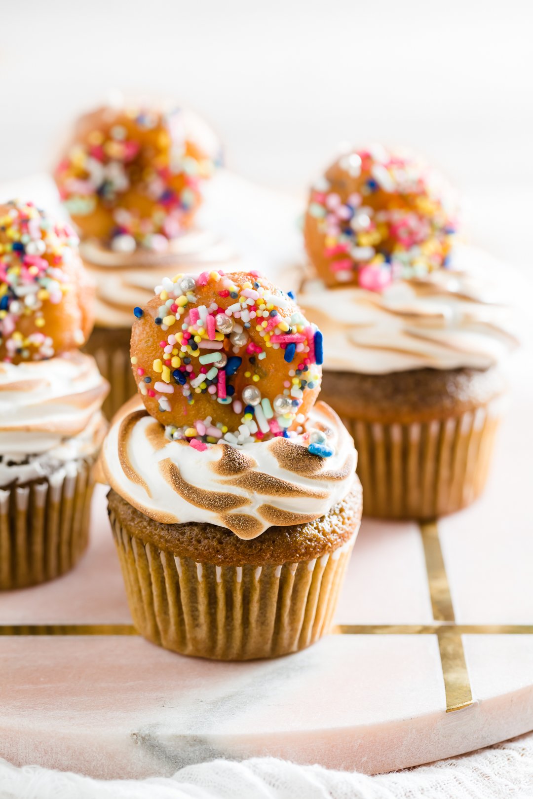 a group of coffee cupcakes with donuts on top of them