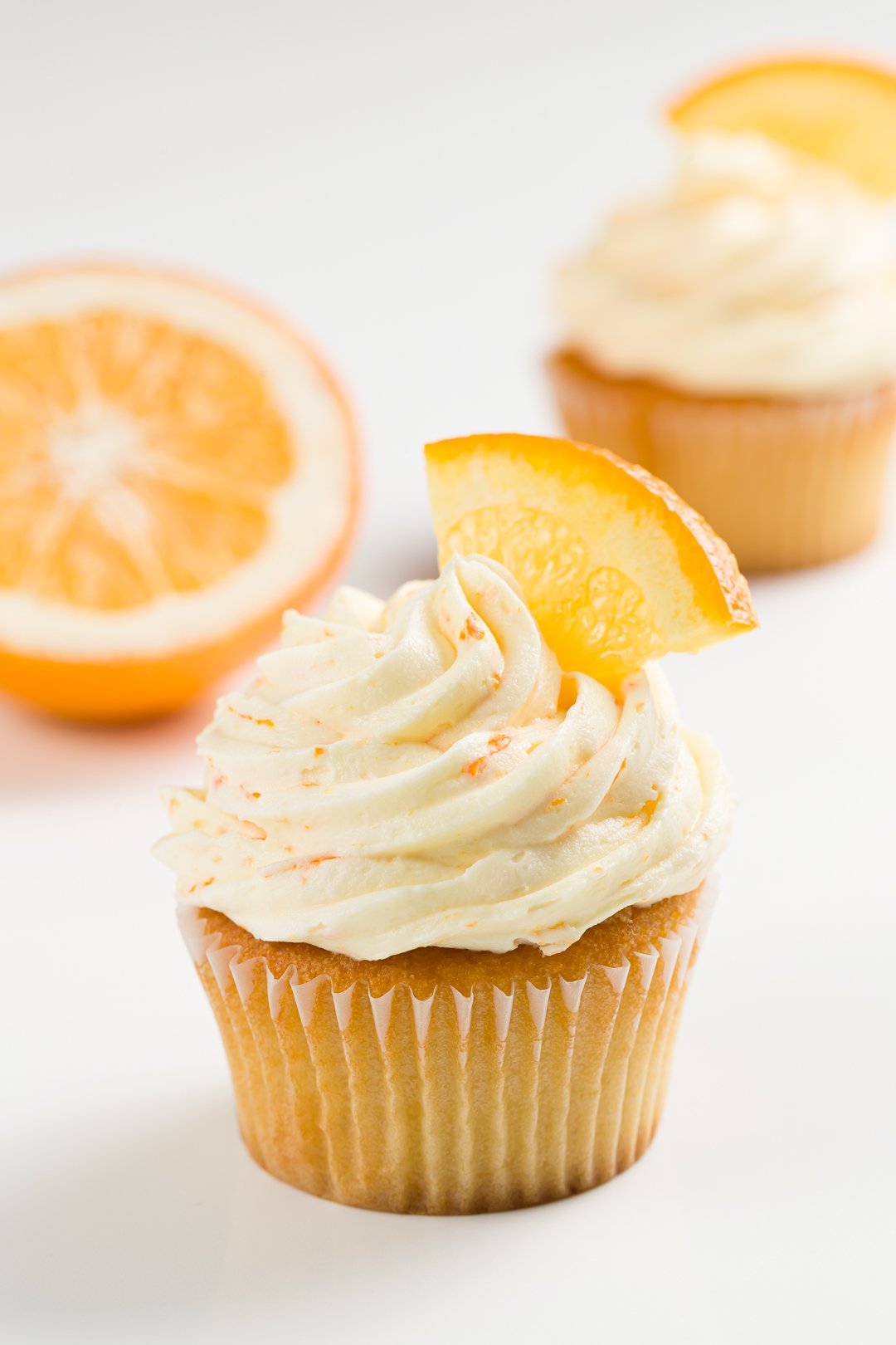 Orange frosting on vanilla cupcakes