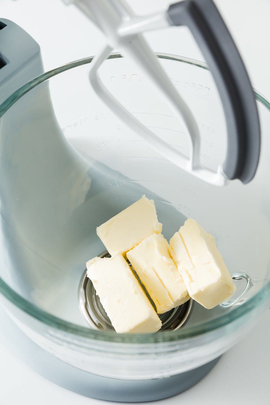 Butter in the bowl of a stand mixer fitted with the paddle attachement