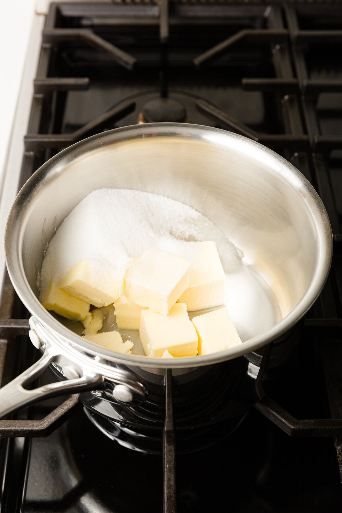 Butter, sugar, salt, and water in a pot on a stove