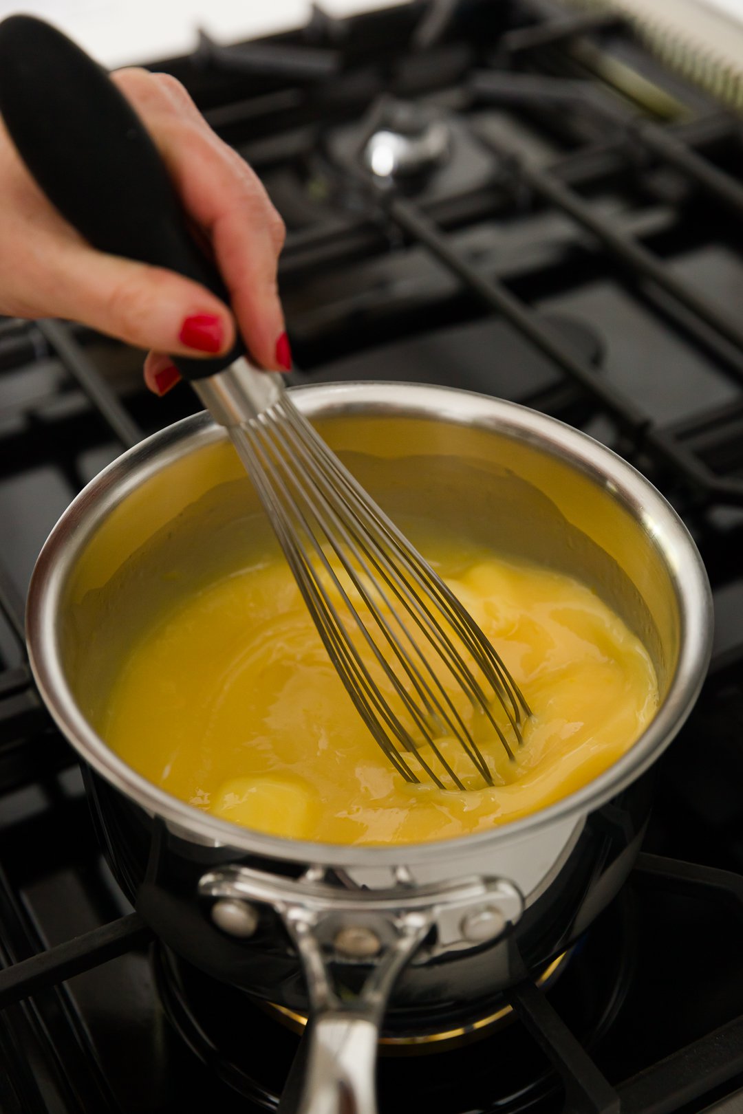 Whisking eggs and other ingredients on stove