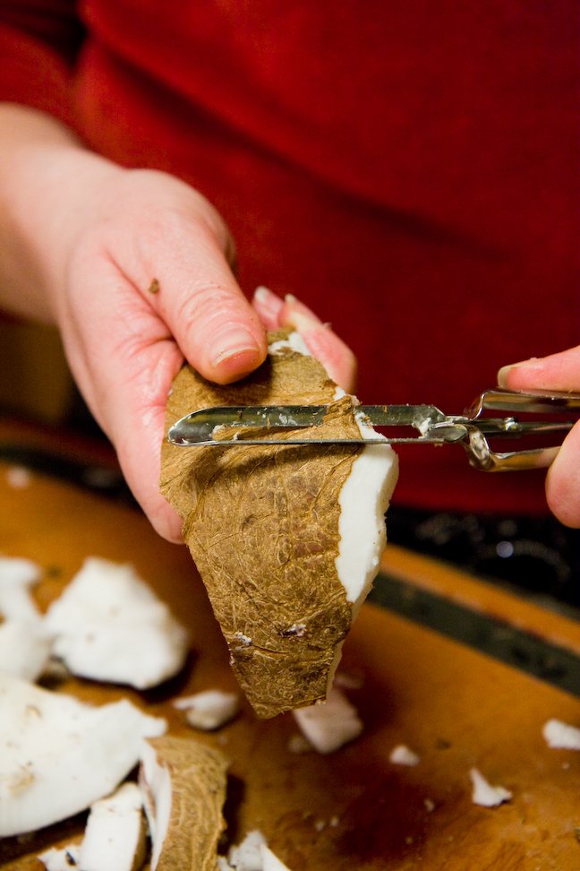 Peeling a coconut with a vegetable peeler
