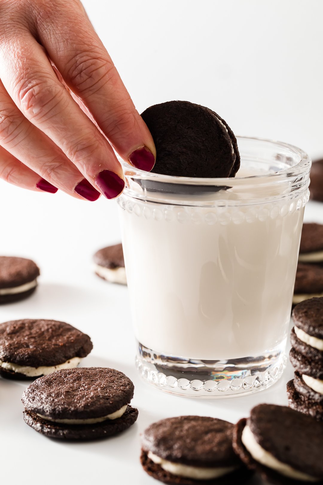 Oreo cookie being dunked in milk