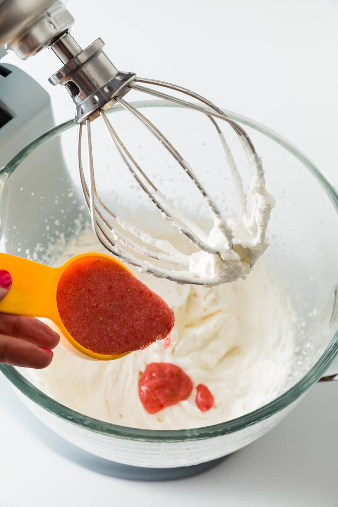 Adding strawberry liquid to whipped cream