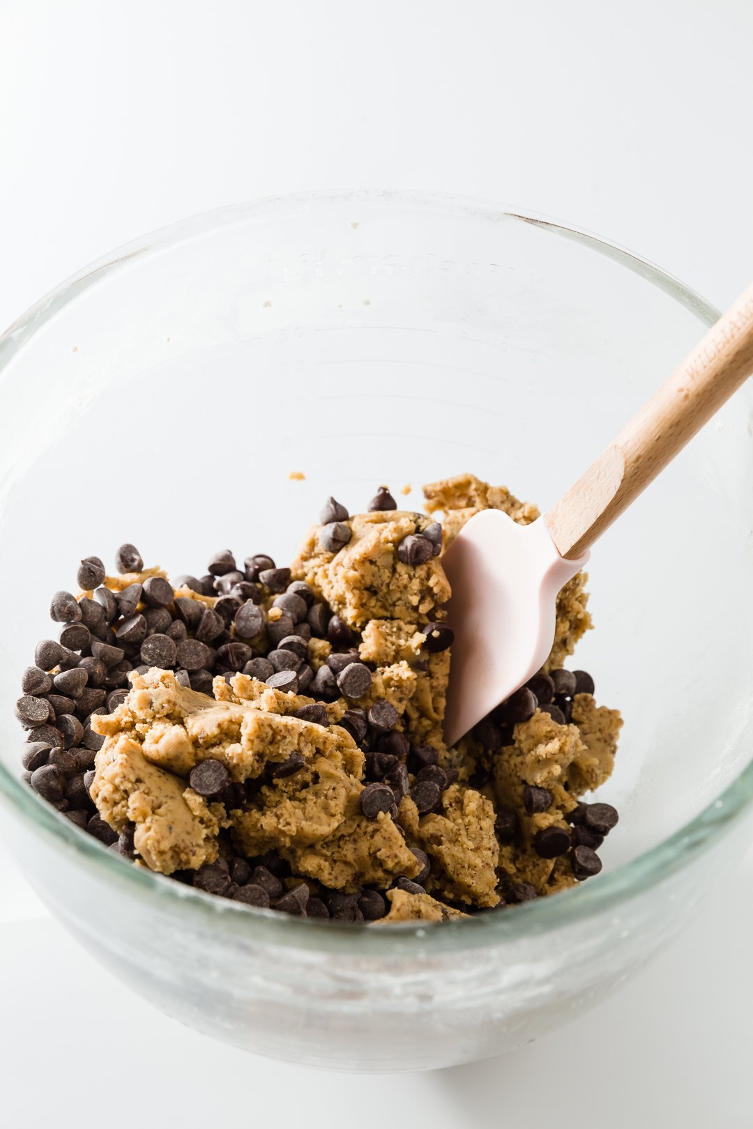 Mixing chocolate chips into cookie dough