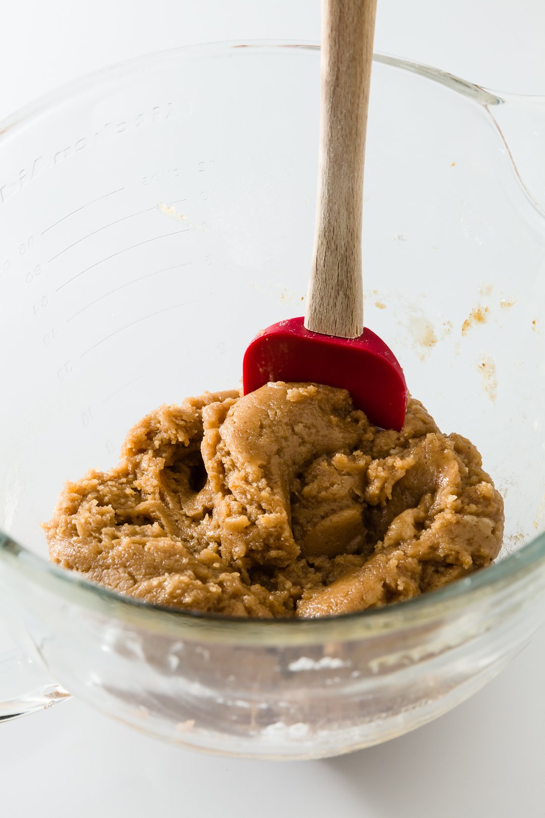 Cookie Dough Frosting in a bowl with a red spatula