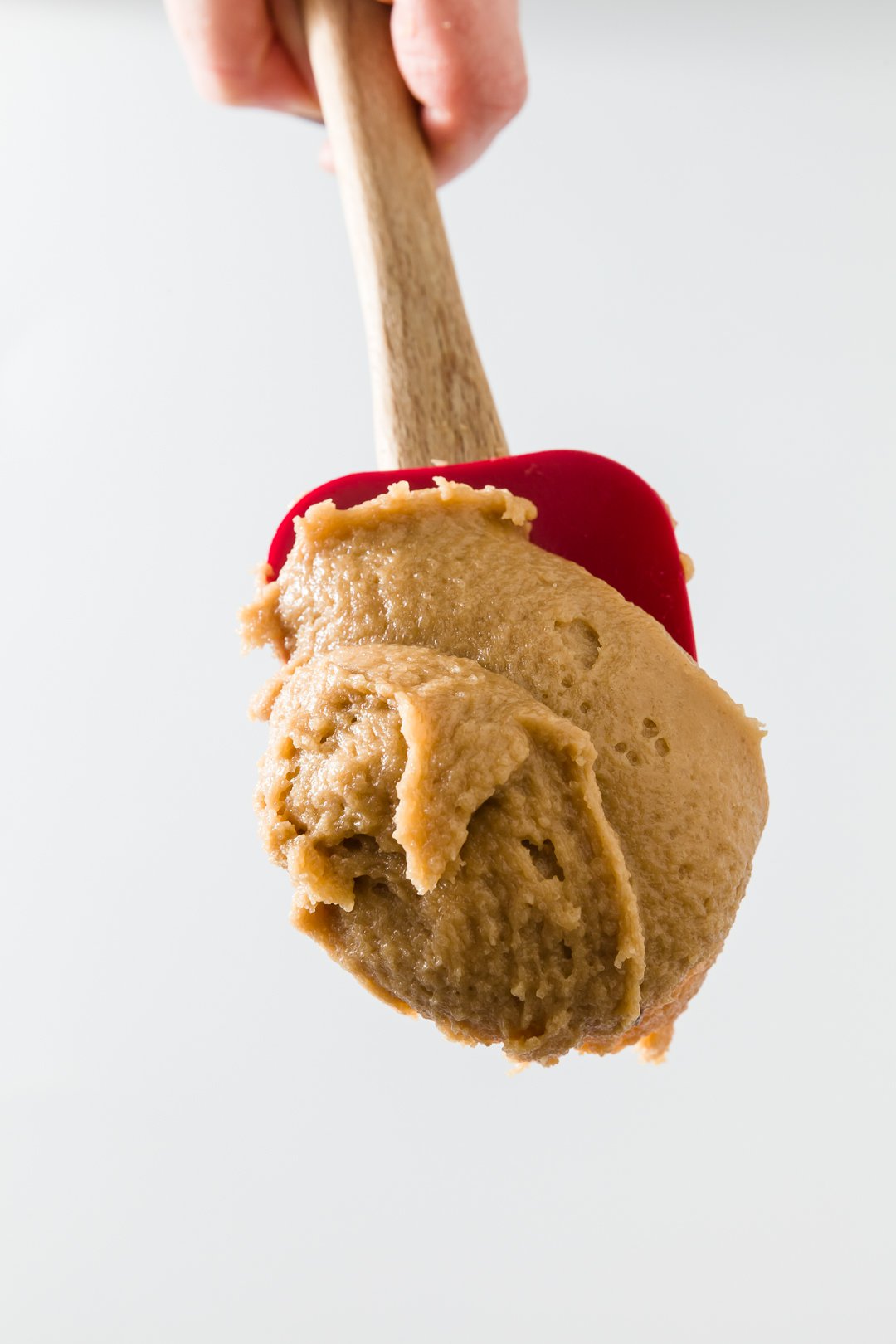 Cookie dough frosting on a red spatula