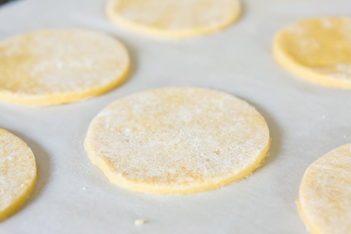 Hamantaschen dough rolled out and cut into circles