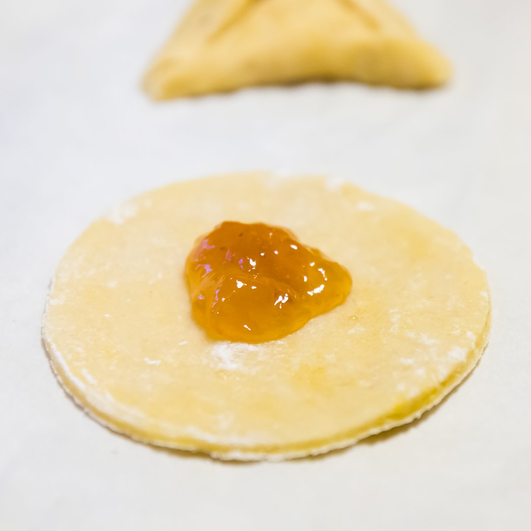 Hamantaschen dough with filling in the center