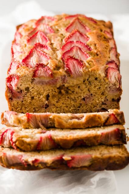 Strawberry banana bread with three slices falling down from it