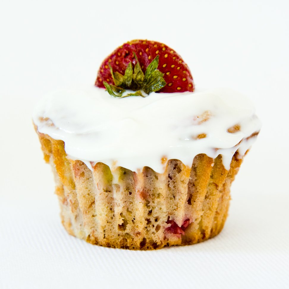 a strawberry banana cupcake with no cupcake liner topped with a strawberry