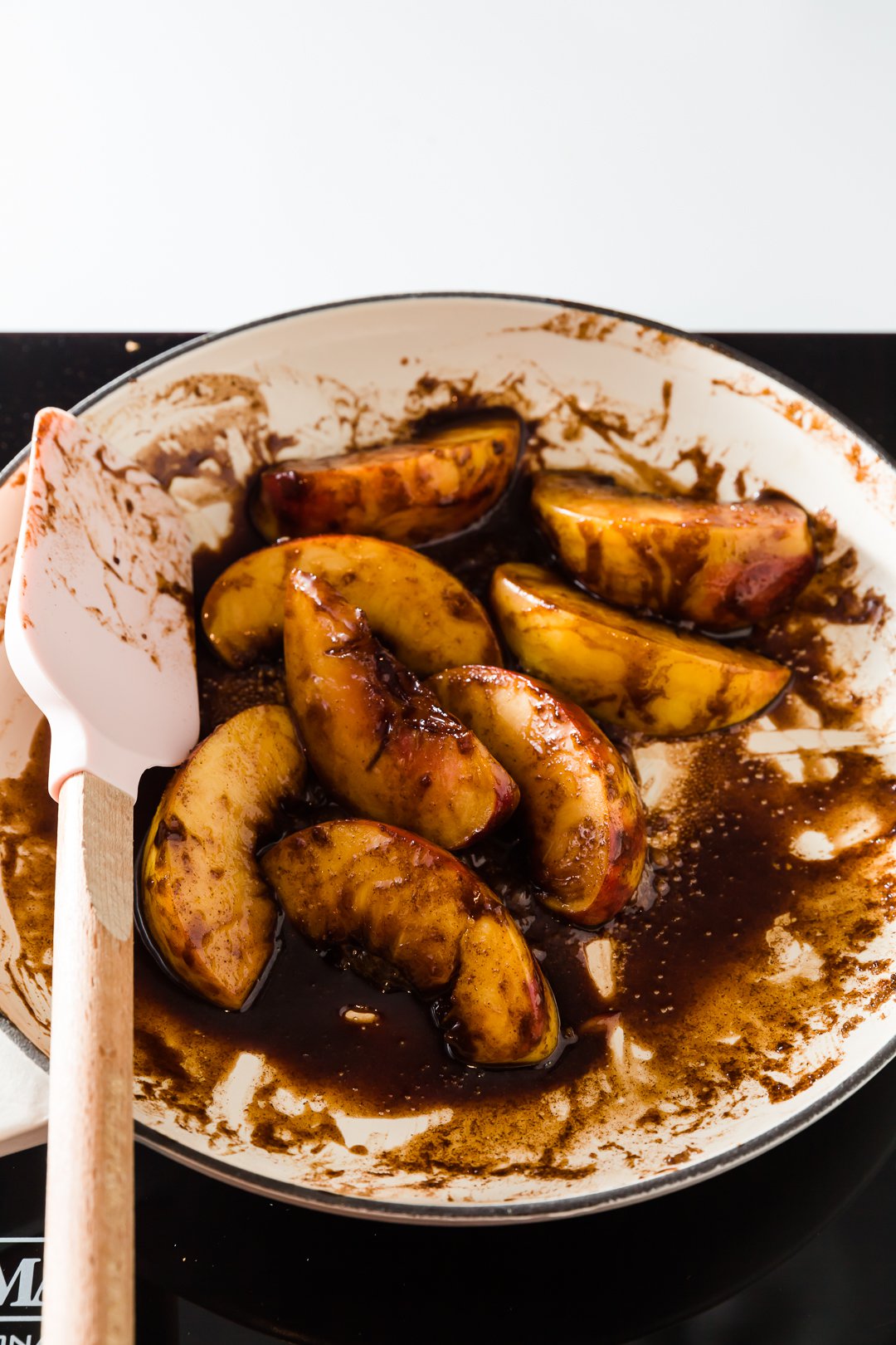 peaches in a skillet with brown sugar and butter