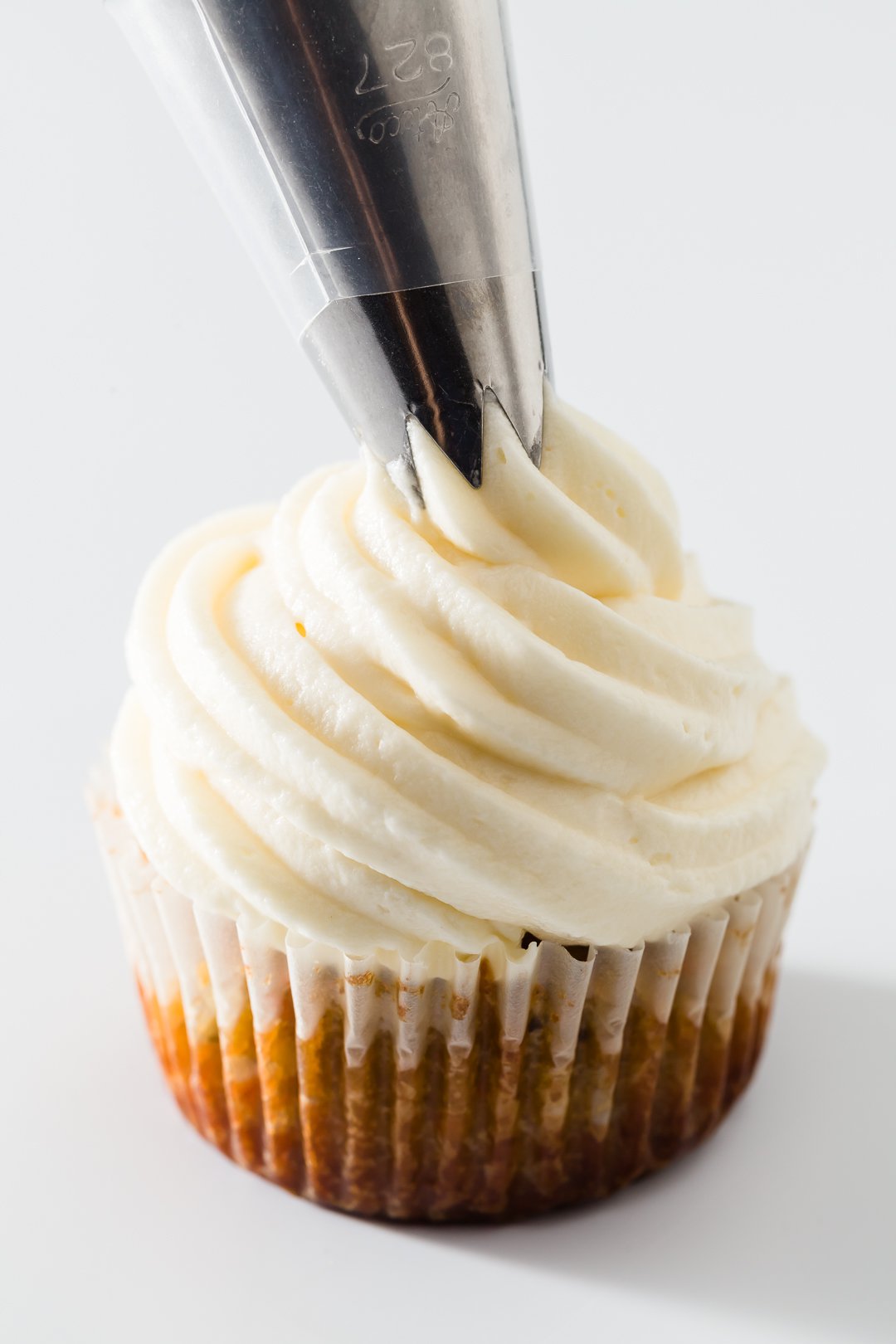 Cream cheese frosting on top of a cupcake