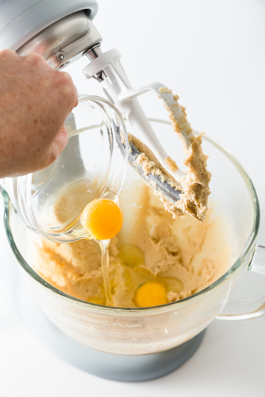 Adding eggs to batter in a stand mixer