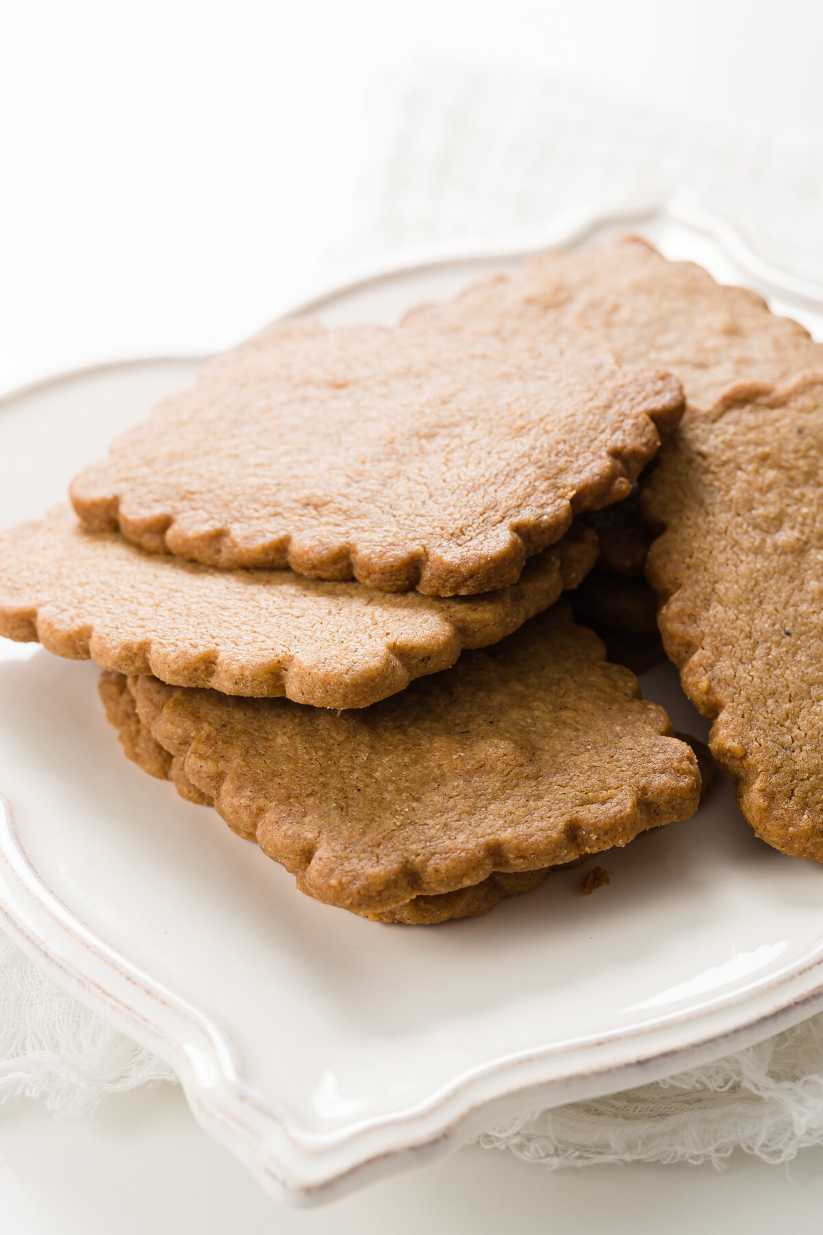 White plate of speculoos cookies in a pile