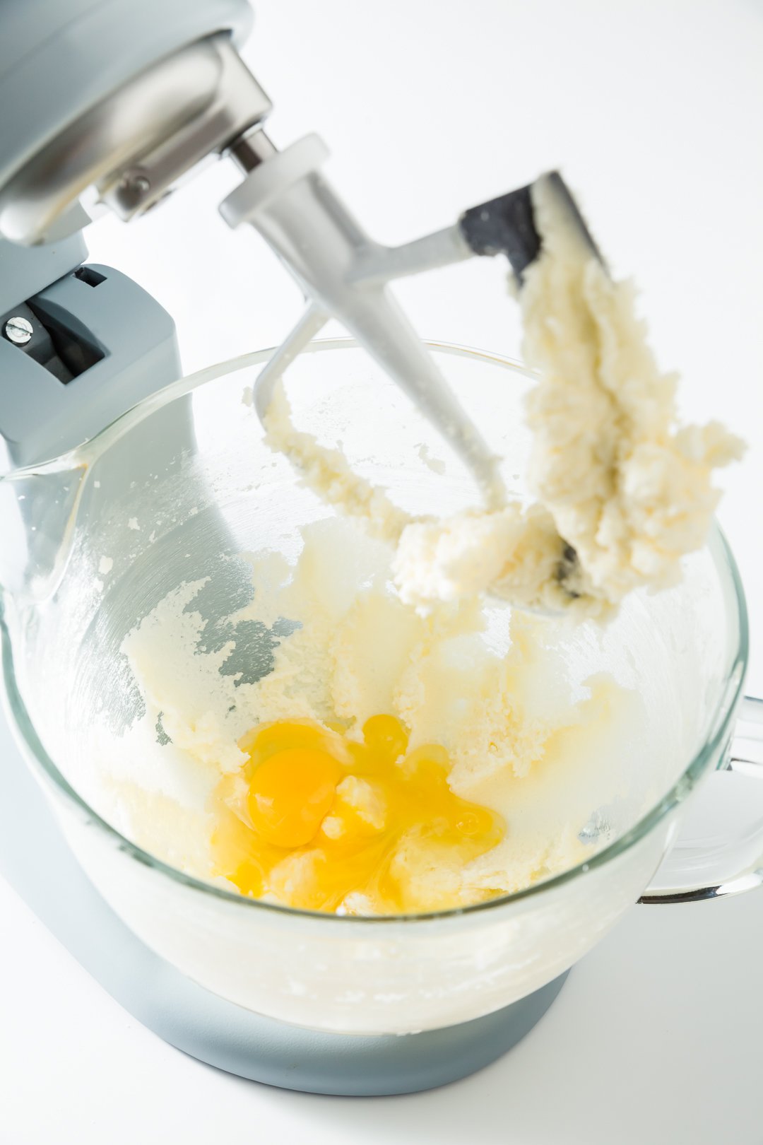 Adding eggs to stand mixer with butter and sugar