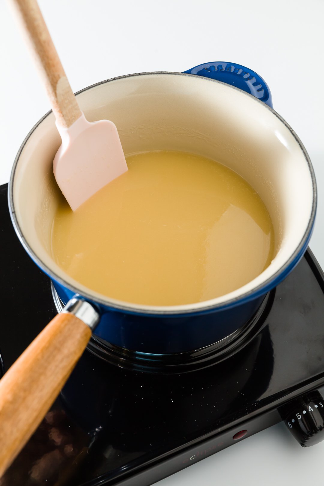 Butter, sugar, and evaporated milk melting in a saucepan