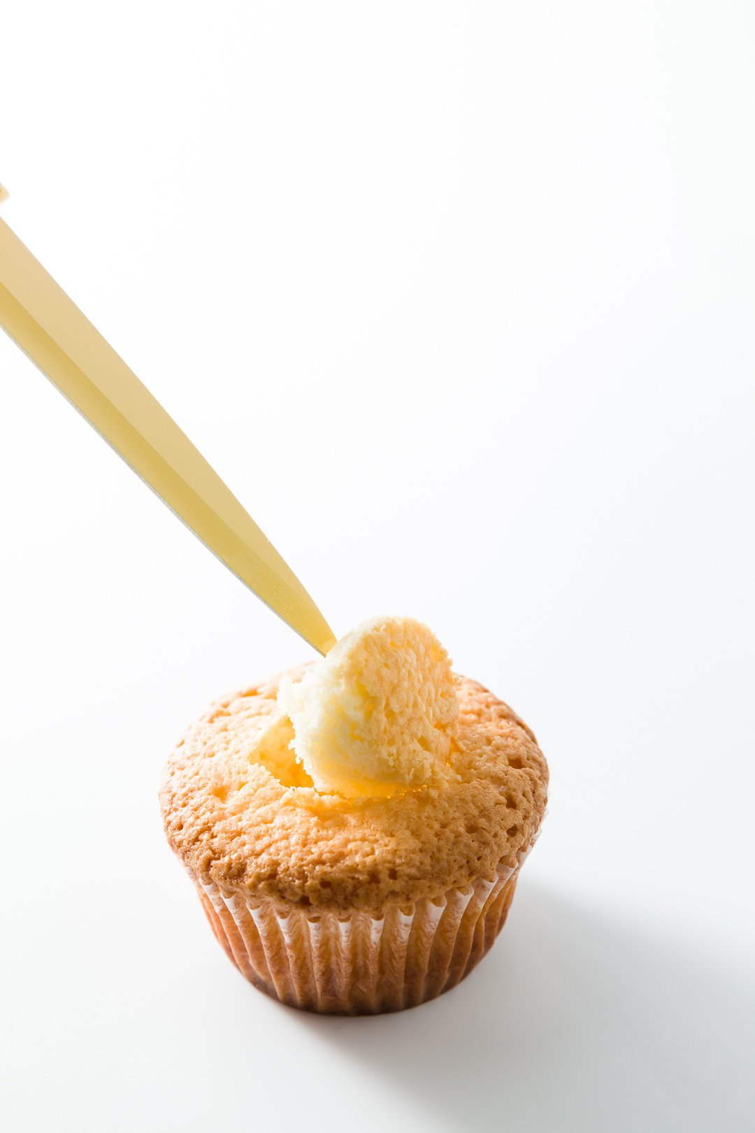 the core of a cupcake being removed with a knife