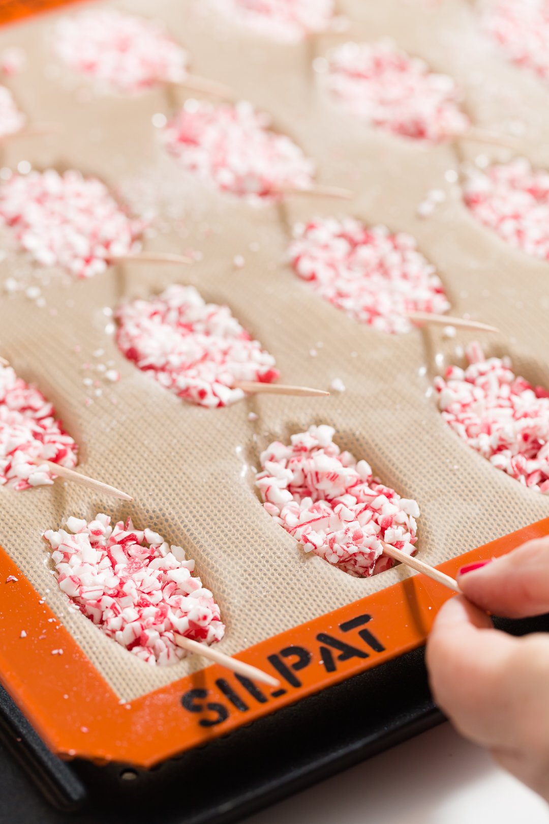 Adding toothpicks to candy cane madeleines