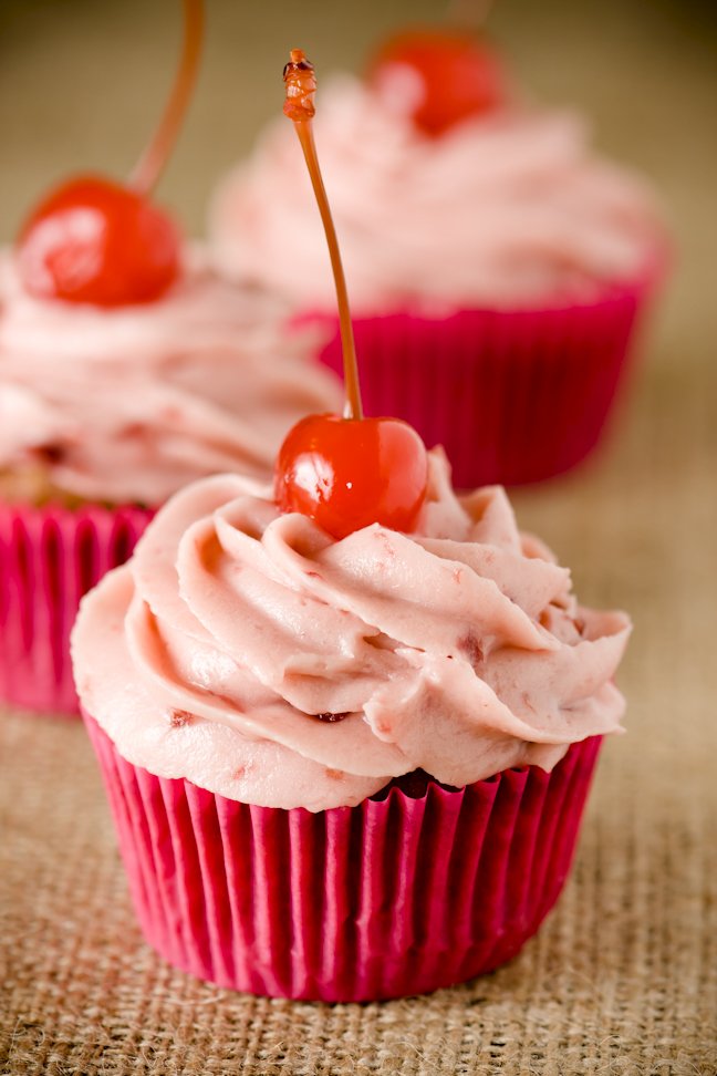 Cupcakes topped with maraschino cherries