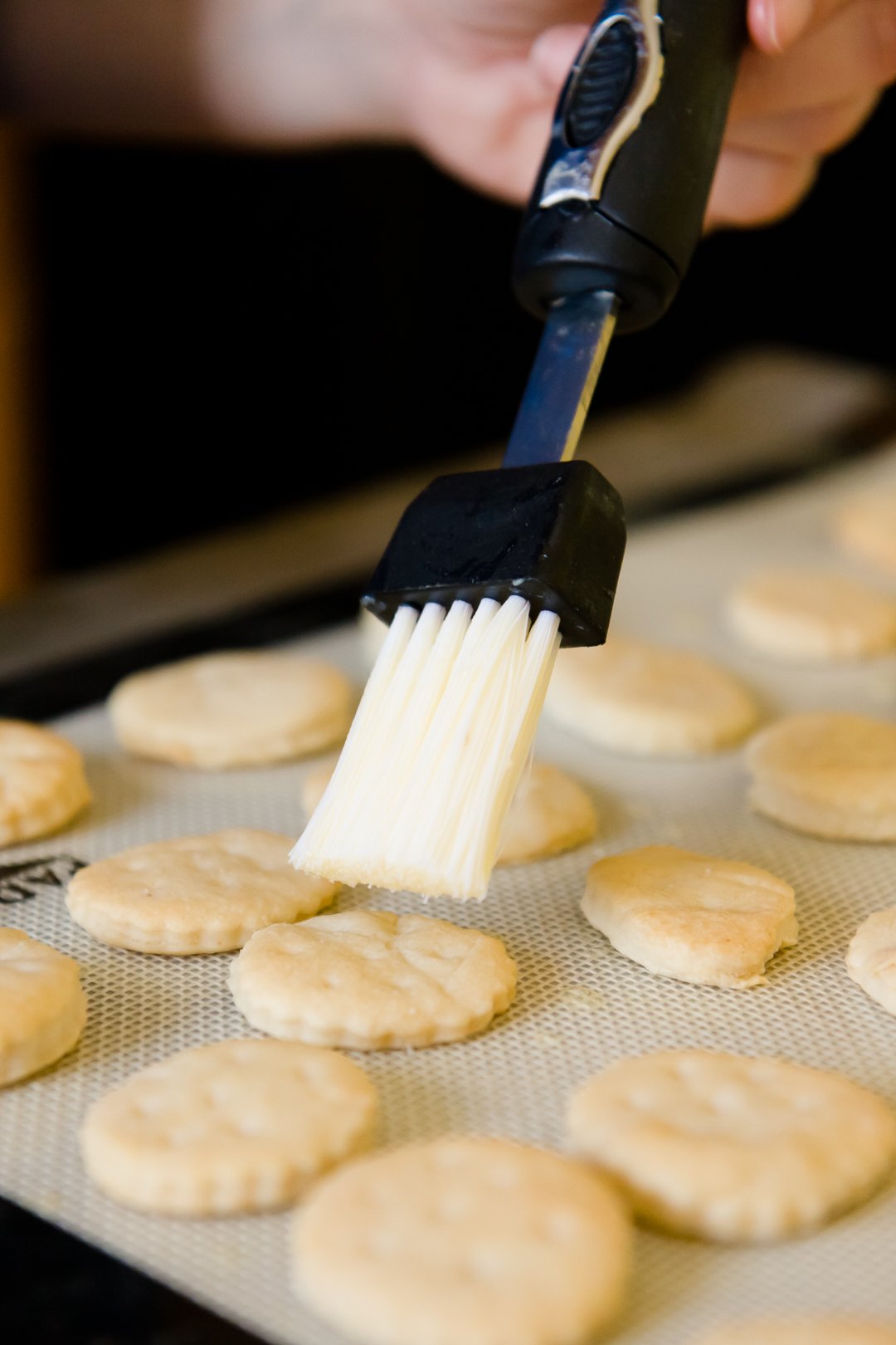 Brushing Ritz crackers with butter