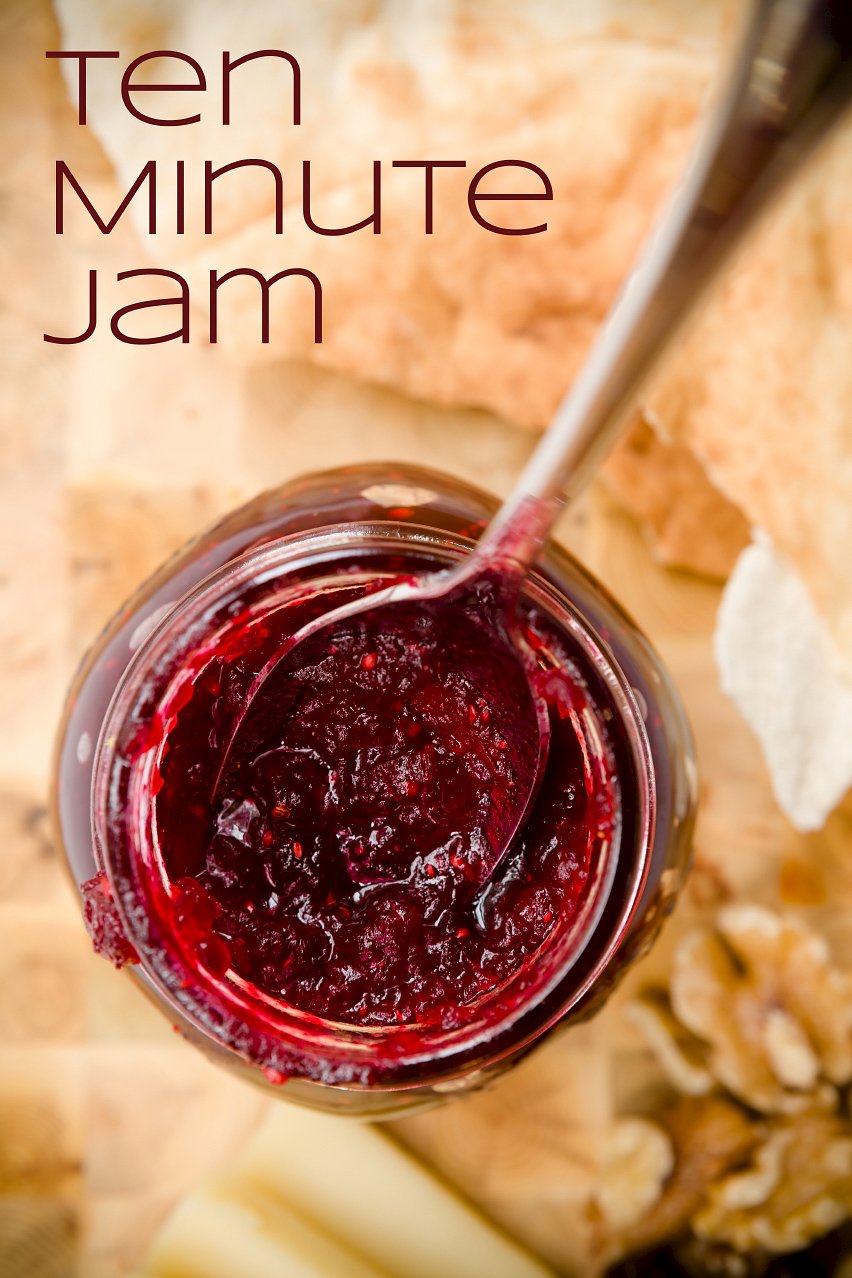 A jar of homemade cranberry jam served with pita