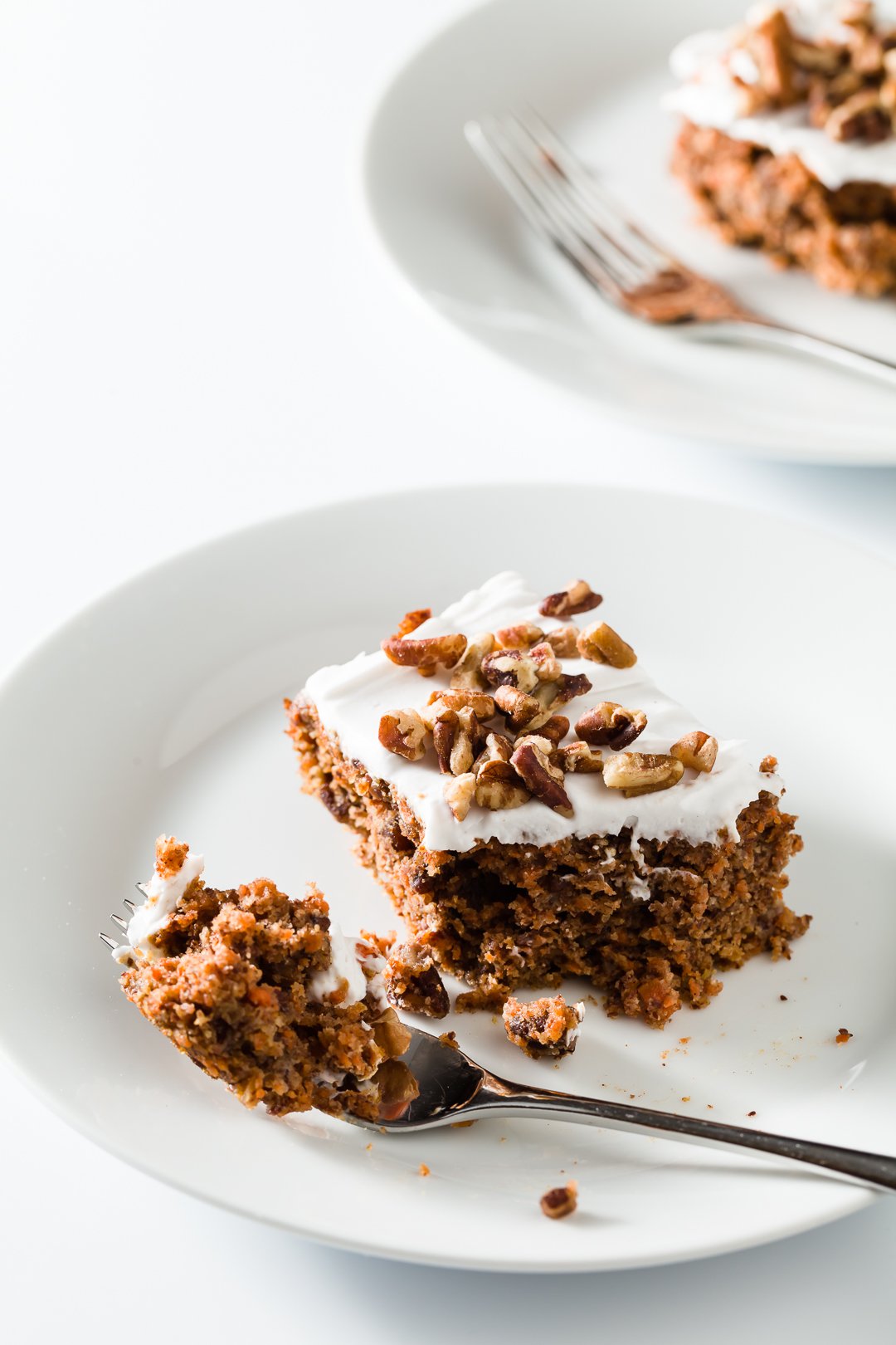 Piece of healthy carrot cake with a bite removed