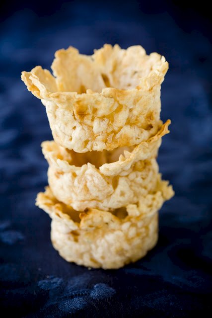 three cups made from matzoh brei stacked on top of each other