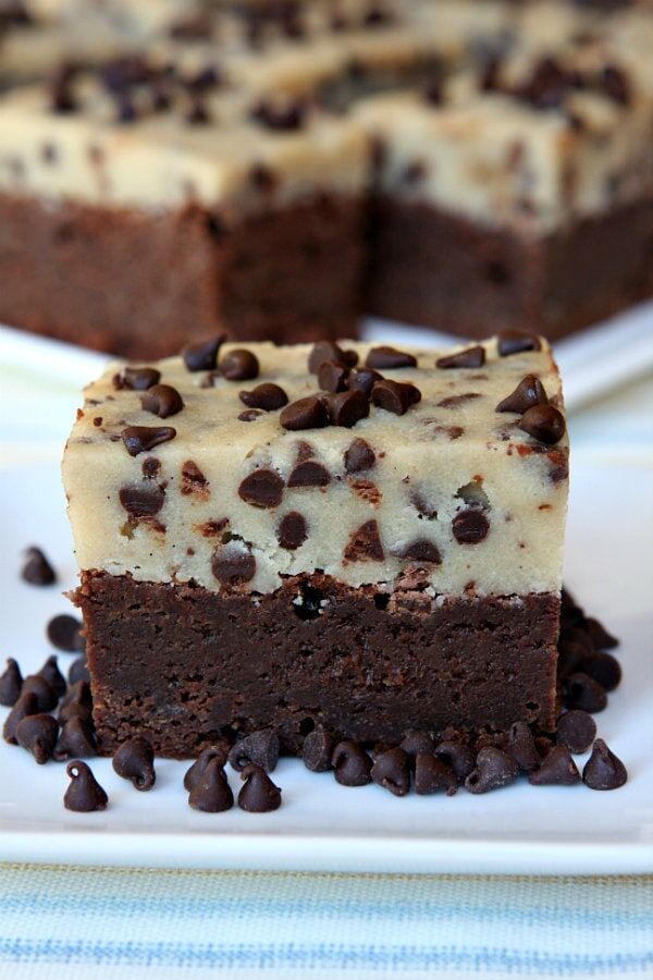 close up of a brownie with chocolate chip cookie dough on top