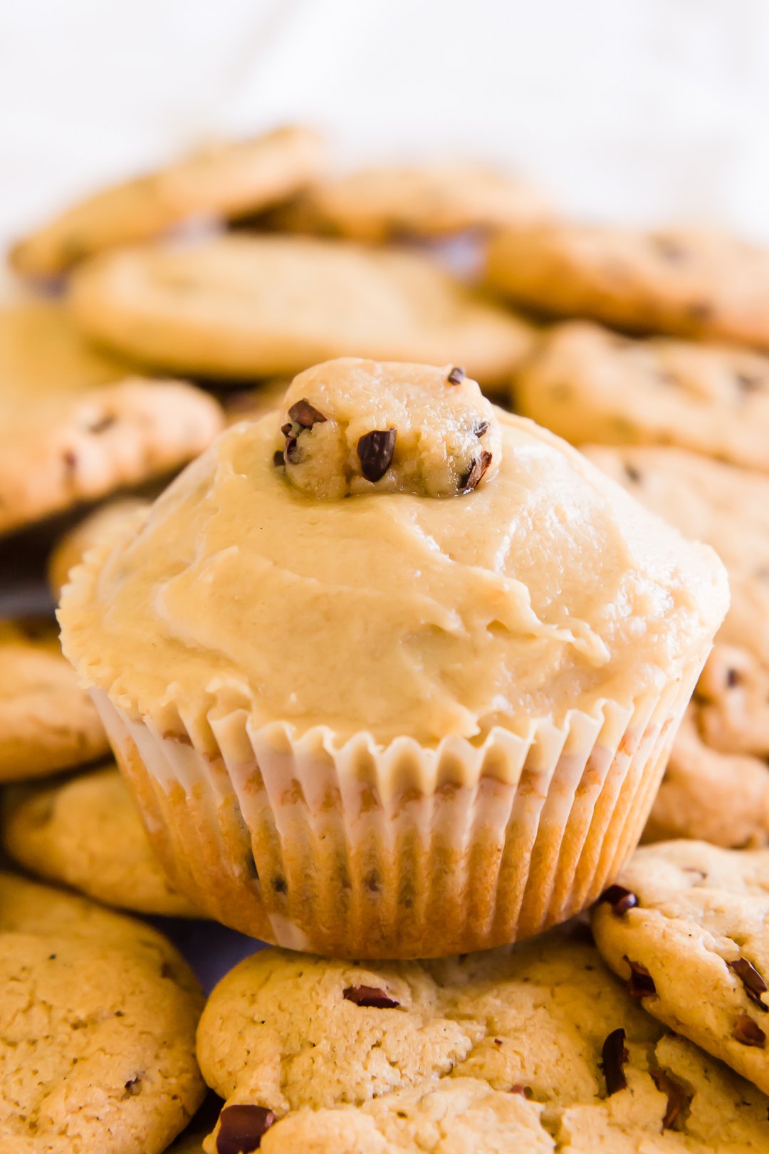 Cookie dough cupcakes on a pile of cookies