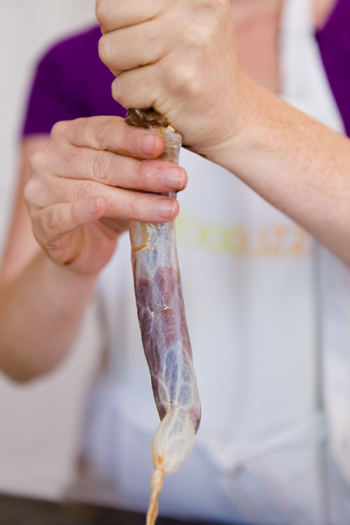 Stef squeezing cupcake batter into a sausage casing