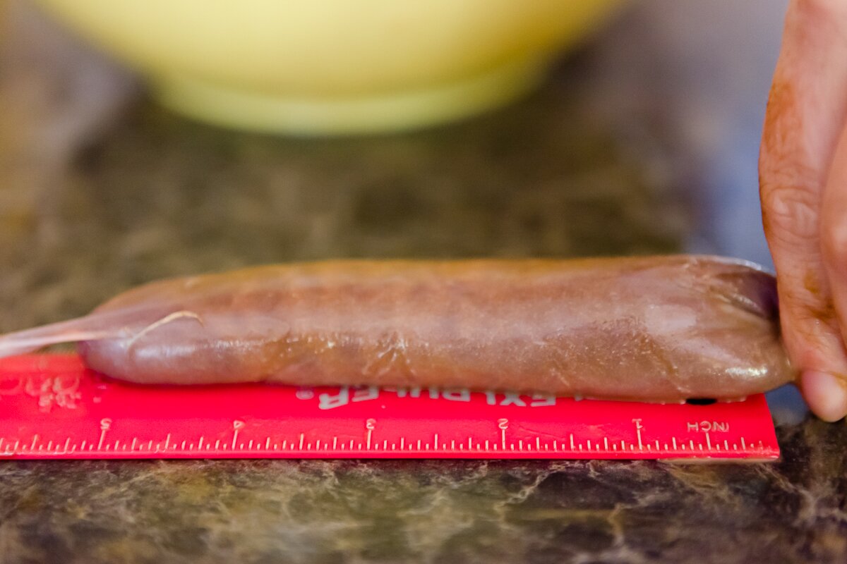 filled dessert sausage next to a ruler showing that it is filled to the 5 inch mark