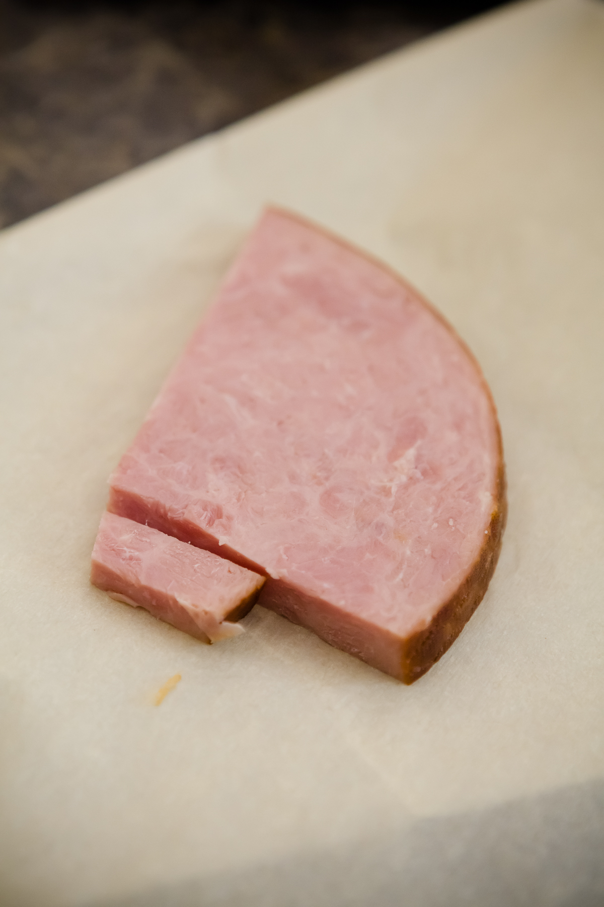a thick slice of ham on parchment paper