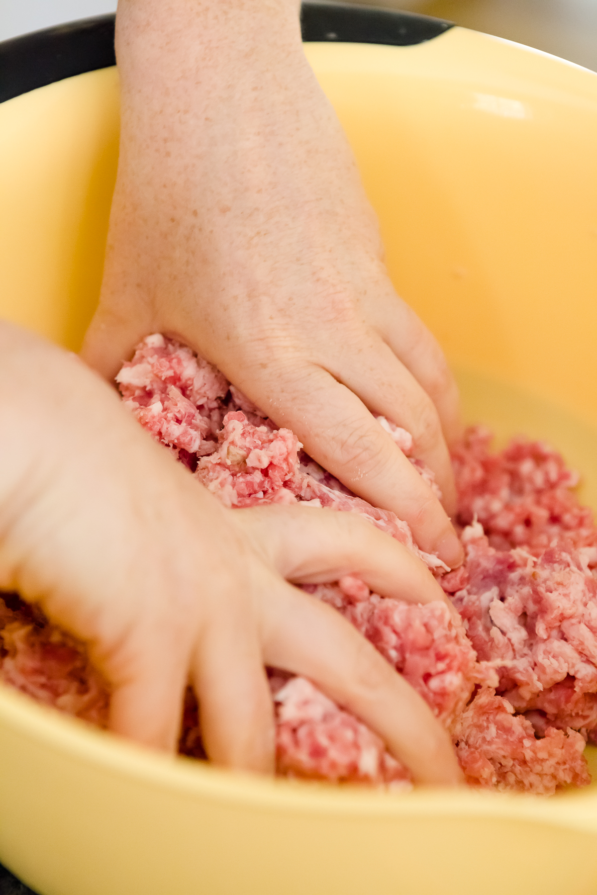 tight shot of Stef's hands mixing homemade Spam ingredients