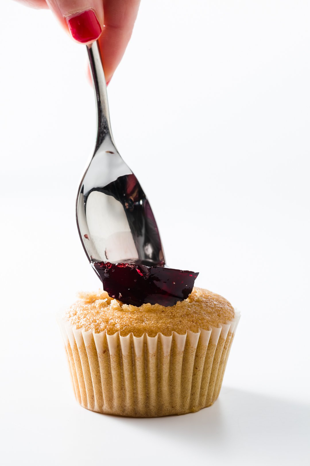 Adding jelly to a peanut butter and jelly cupcake