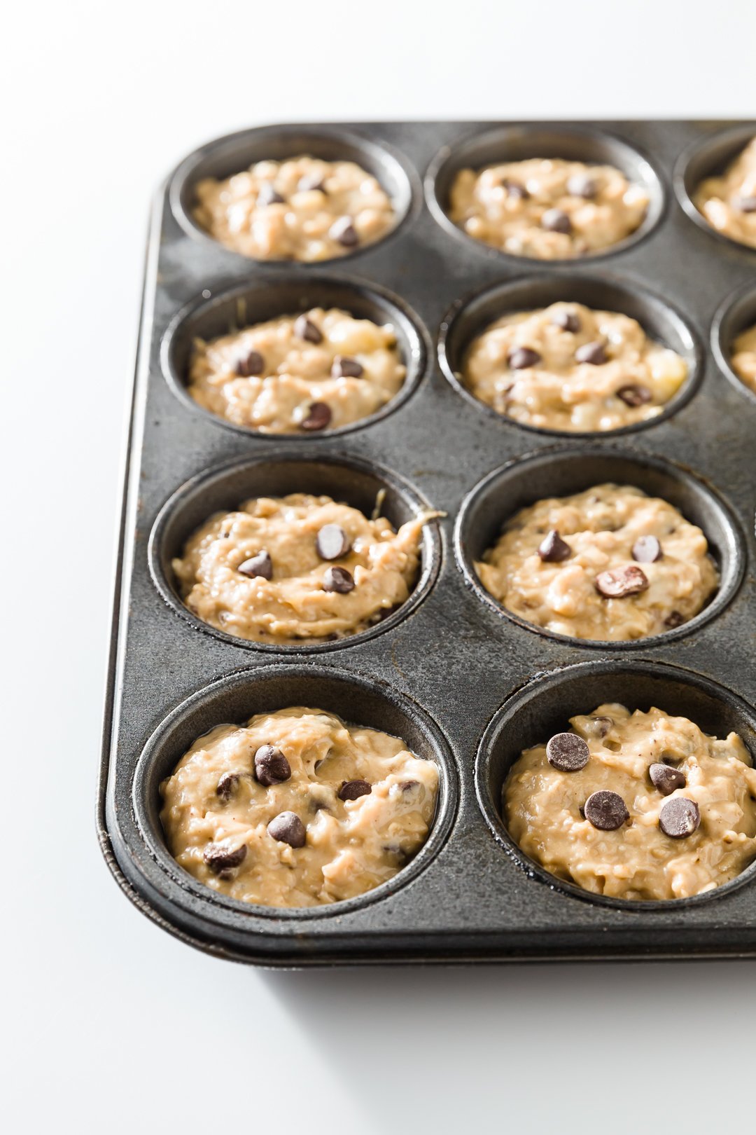 Uncooked muffins in muffin tin