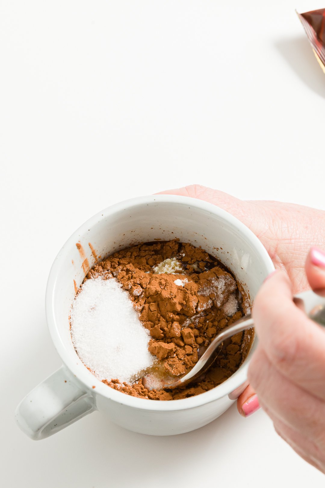 stirring ingredients in a mug