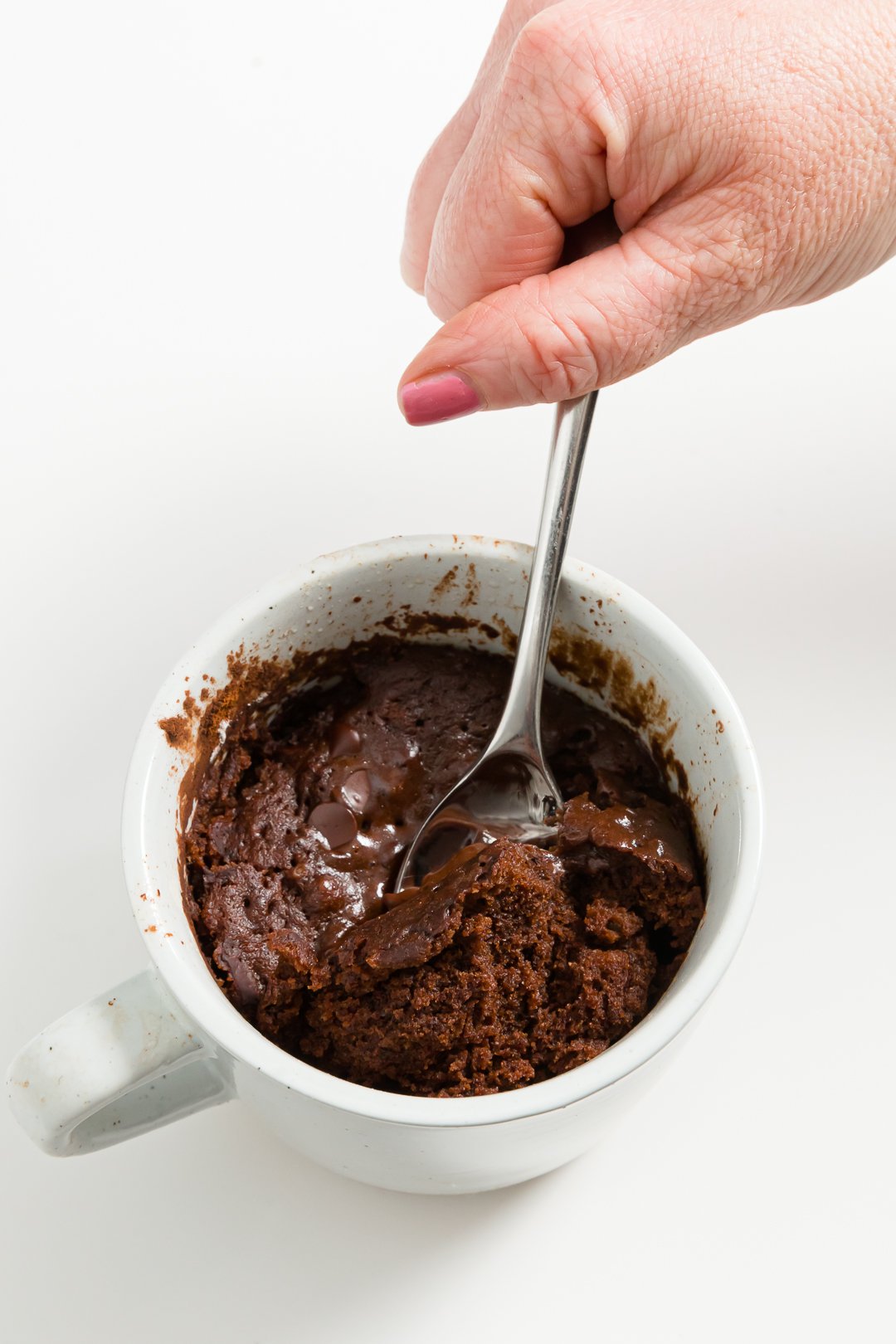 Getting a spoonful of chocolate mug cake