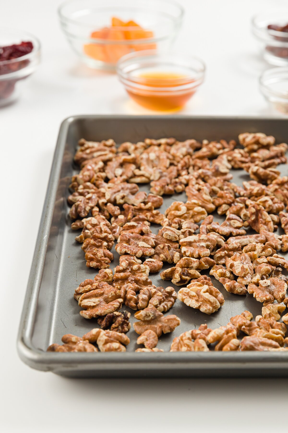 Cookie sheet filled with toasted walnuts