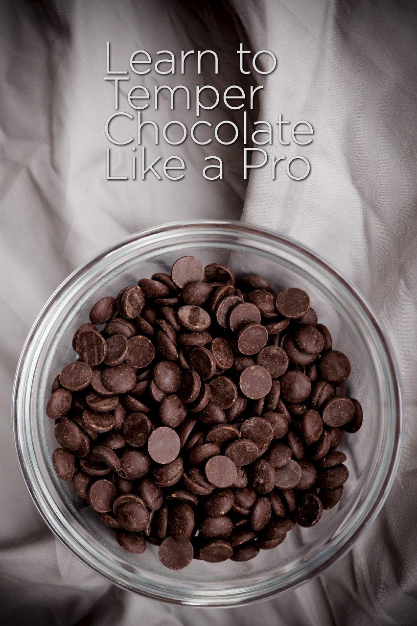 bowl of chocolate chips with the text "how to temper chocolate like a pro"