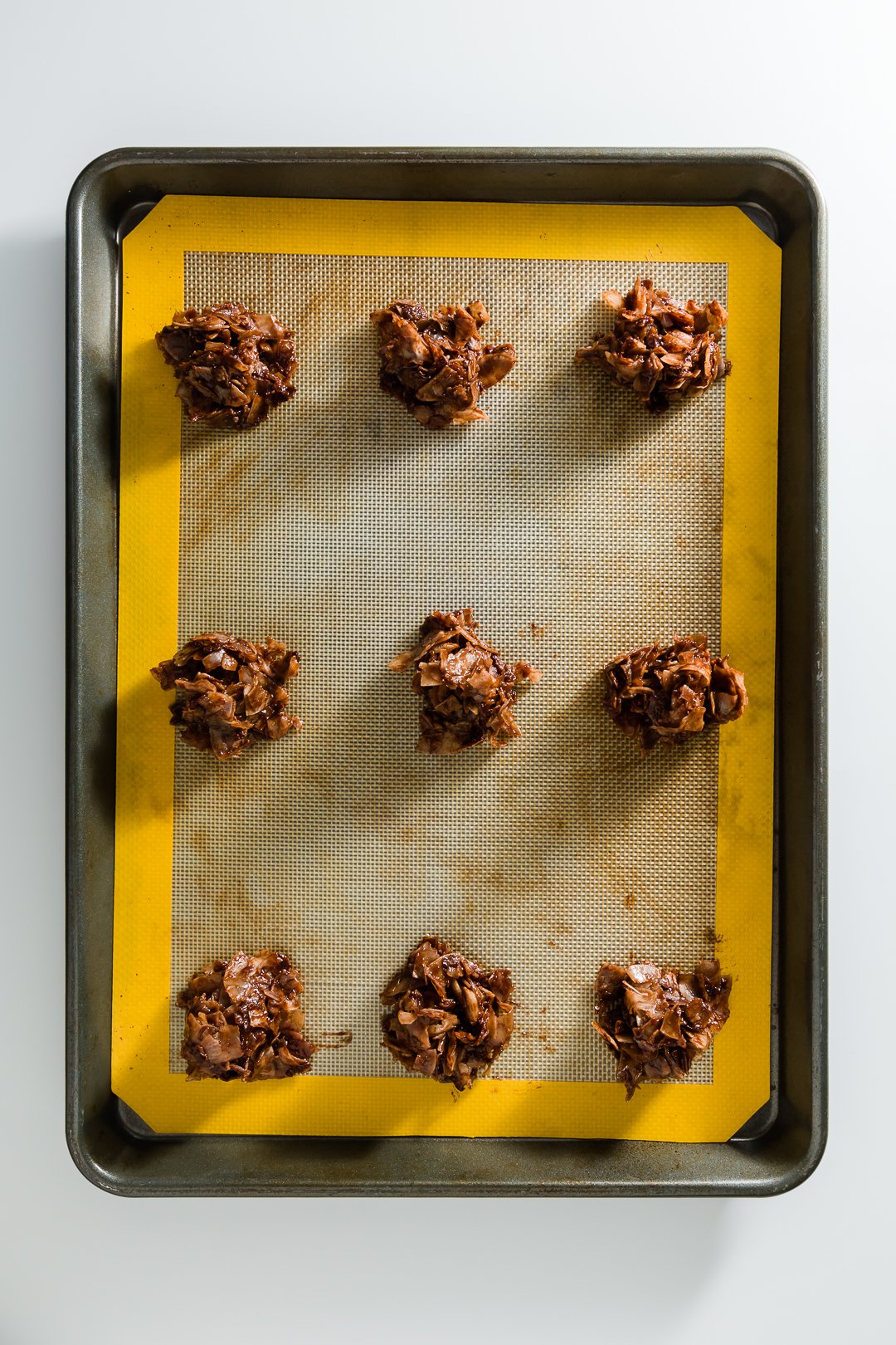 a tray of chocolate macaroons ready to go into the oven