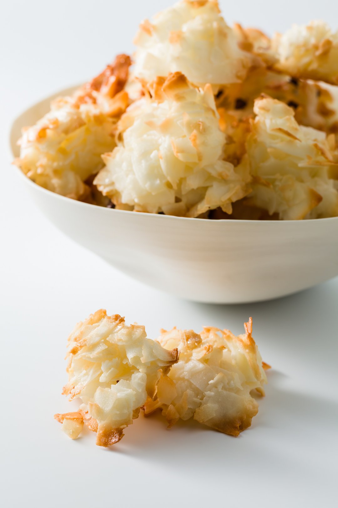 Bowl of coconut macaroons with two in the front