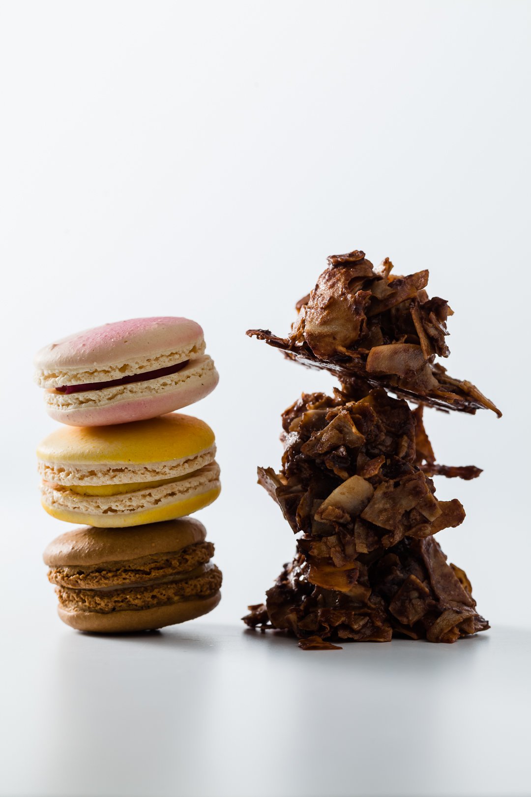 A stack of macaroons next to a stack of macaroons