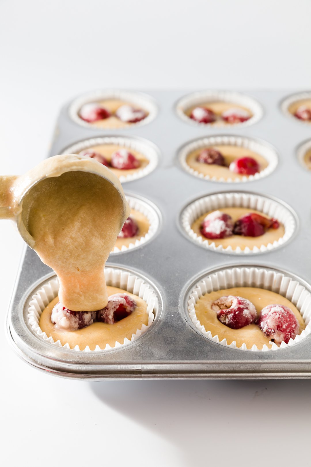 covering cherry filled batter with more batter