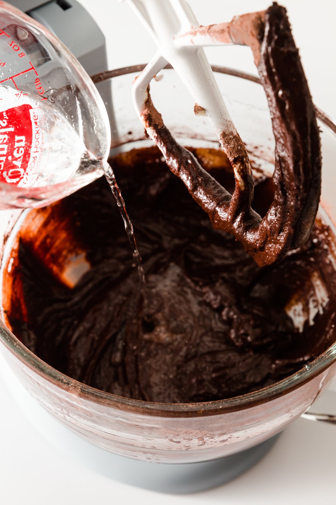 adding water to chocolate cupcake batter