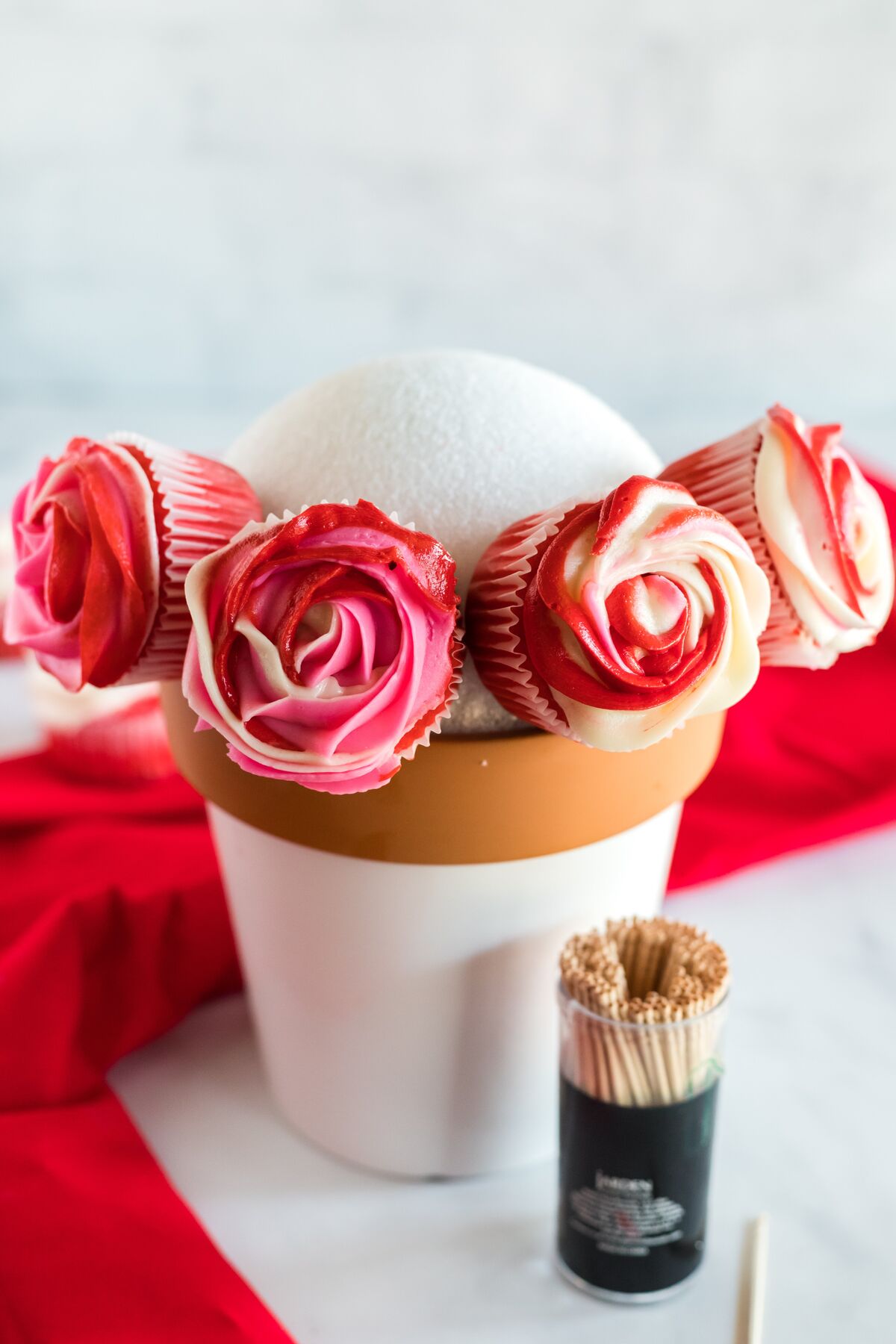 adding cupcakes to bouquet