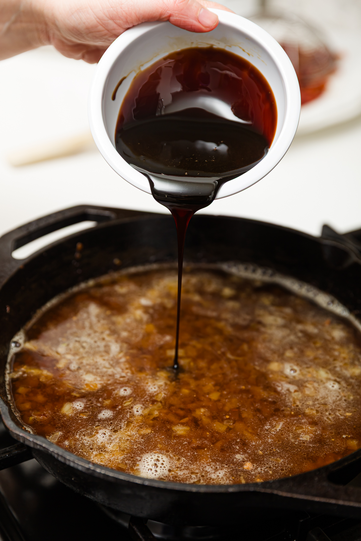 Adding molasses to the bourbon bacon jam pan
