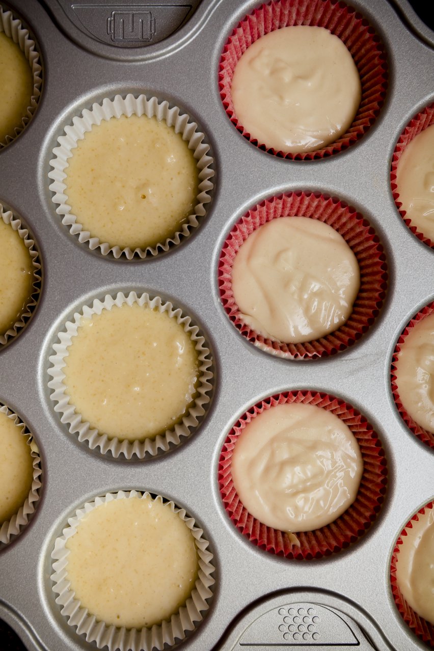 Properly-mixed cake batter vs over-mixed cake batter in liners in a cupcake tin