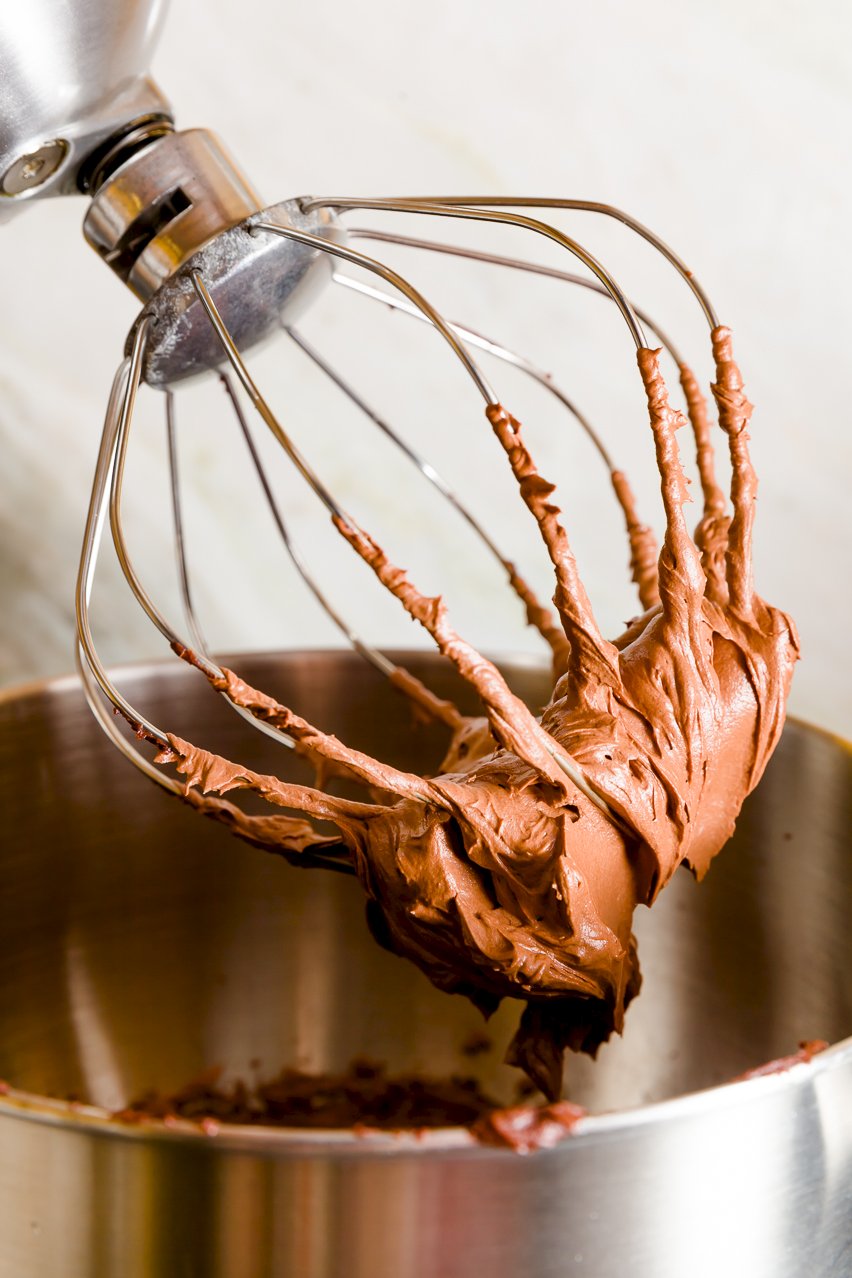 Whipped ganache stuck to a mixer's whisk attachment