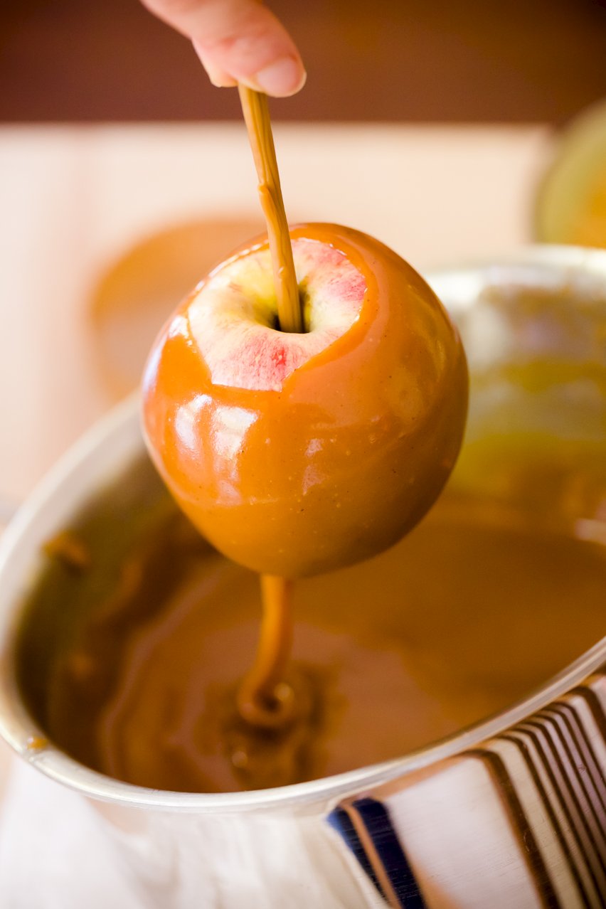 Dipping an apple in caramel